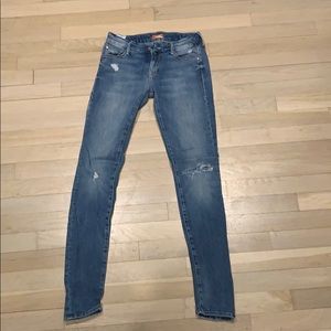 Blue MOTHER jeans that are ripped
